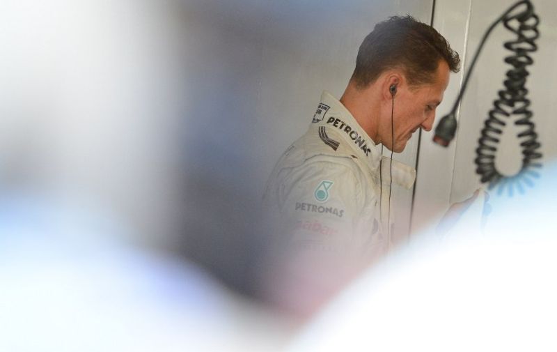 Mercedes driver Michael Schumacher of Germany leaves his pit after the first free practice session at his pit in the Formula One Japanese Grand Prix in the Suzuka circuit on October 5, 2012.     AFP PHOTO/Toru YAMANAKA / AFP / TORU YAMANAKA