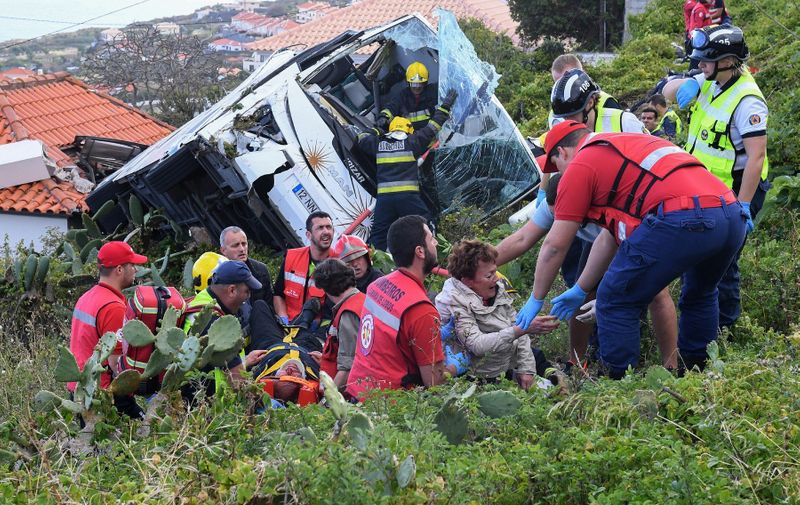 Firemen help victims of a tourist bus that crashed on April 17, 2019 in Caniço, on the Portuguese island of Madeira.
 At least 28 people were killed when a tourist bus crashed on the Portuguese island of Madeira, the local mayor told local media. The regional protection service did not confirm the toll when questioned by AFP., Image: 426580828, License: Rights-managed, Restrictions: , Model Release: no, Credit line: Profimedia, AFP