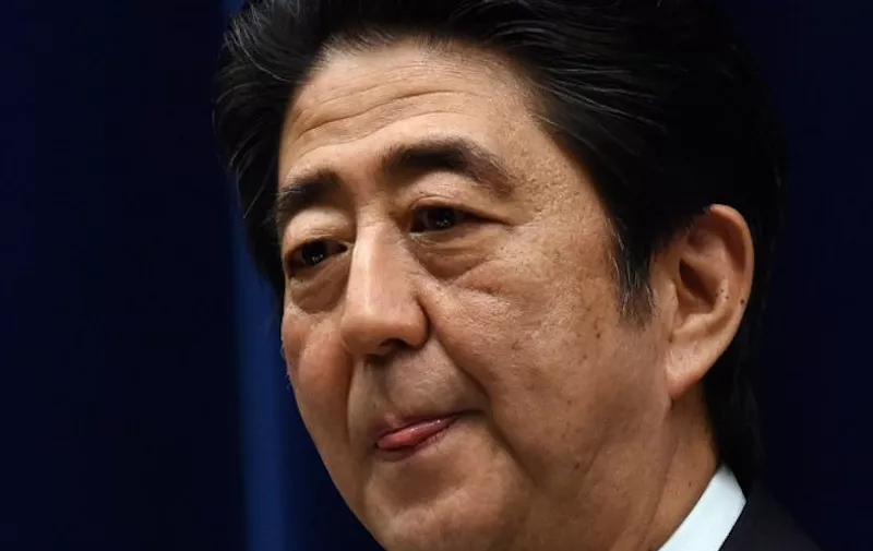 Japan's Prime Minister Shinzo Abe delivers a speech during a press conference following a cabinet meeting which approved a set of bills bolstering the role and scope of the military, at his official residence in Tokyo on May 14, 2015. The bills are a pet project of nationalist Prime Minister Abe, who says Japan can no longer shy away from its responsibility to help safeguard regional stability, and must step out from under the shade of the security umbrella provided by the United States.       AFP PHOTO / TOSHIFUMI KITAMURA