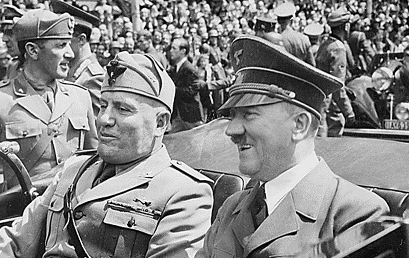 This file photo taken in June 1940, in Munich, Germany, shows Adolf Hitler (R) riding in a car with Italian Fascist dictator , Benito Mussolini (L) during World War II. AFP PHOTO/HO (Photo by THE NATIONAL ARCHIVES / AFP)