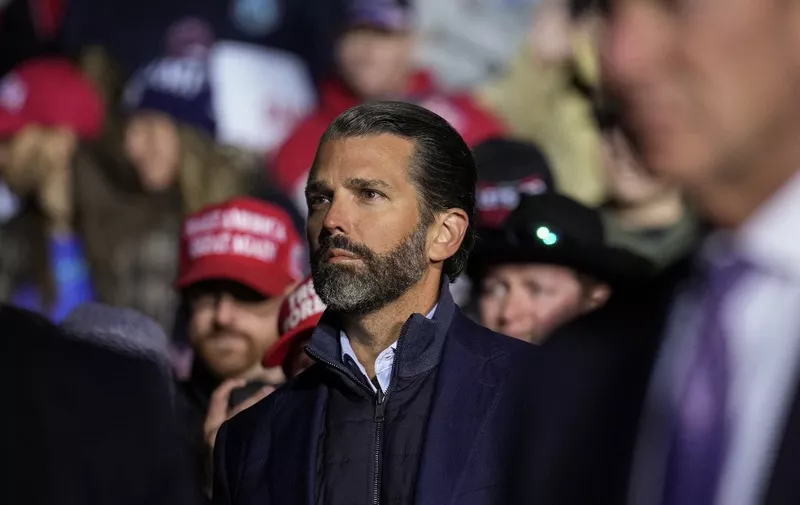 VANDALIA, OHIO - NOVEMBER 07: Donald Trump Jr. listens as former President Donald Trump speaks at a rally at the Dayton International Airport on November 7, 2022 in Vandalia, Ohio. The former president is campaigning for Republican candidates, including U.S. Senate candidate JD Vance, who faces U.S. Rep. Tim Ryan (D-OH) in tomorrow's general election.   Drew Angerer/Getty Images/AFP (Photo by Drew Angerer / GETTY IMAGES NORTH AMERICA / Getty Images via AFP)