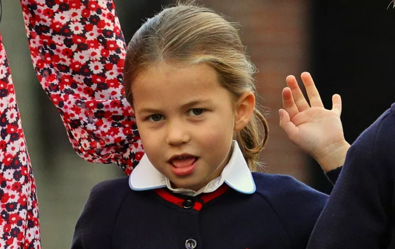 Britain's Princess Charlotte of Cambridge gestures as she arrives for her first day of school at Thomas's Battersea in London on September 5, 2019. (Photo by Aaron Chown / POOL / AFP)