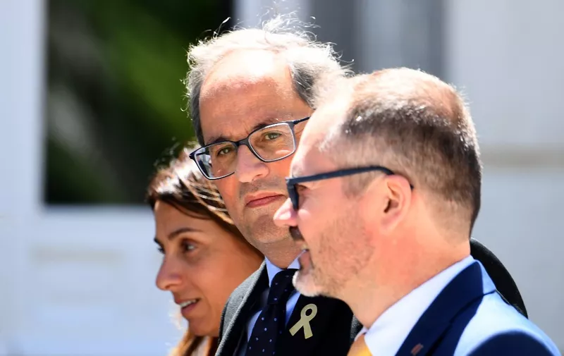 Catalan regional president Quim Torra (C) arrives at the Supreme Court in Madrid on June 12, 2019 to attend the final hearings on the trial of 12 Catalan separatist leaders over their role in Catalonia's failed 2017 independence bid. (Photo by GABRIEL BOUYS / AFP)