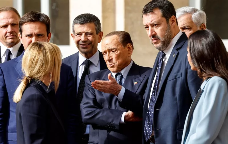 Former Prime Minister and leader of Forza Italia (FI) party Silvio Berlusconi (C) speaks with President of the Italian party Fratelli d'Italia (Brothers of Italy) Giorgia Meloni (L), next to Italian Lega party leader Matteo Salvini (2nd R) as they leave after a meeting with Italian President Sergio Mattarella for the first round of formal political consultations for new government at the Quirinale Palace in Rome on October 21, 2022. (Photo by FABIO FRUSTACI / ANSA / AFP) / Italy OUT