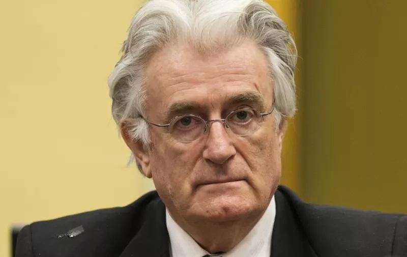 (FILES) This file photo taken on July 11, 2013 shows Bosnian Serb wartime leader Radovan Karadzic appearing in the courtroom for his appeal judgement at the International Criminal Tribunal for Former Yugoslavia (ICTY) in The Hague, The Netherlands.
Now 70, father-of-two Karadzic will hear a verdict on March 24, 2016 from the UN Yugoslav tribunal over 11 counts of war crimes, crimes against humanity and genocide. The worst atrocity on the charge-sheet is the massacre of almost 8,000 Muslim men and boys in the eastern town of Srebrenica in July 1995. / AFP / POOL / MICHAEL KOOREN