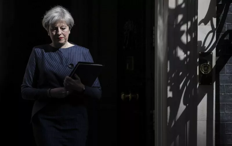 British Prime Minister Theresa May walks out of 10 Downing Street to speak to media in central London on April 18, 2017.
British Prime Minister Theresa May called today for an early general election on June 8 in a surprise announcement as Britain prepares for delicate negotiations on leaving the European Union. / AFP PHOTO / Daniel LEAL-OLIVAS