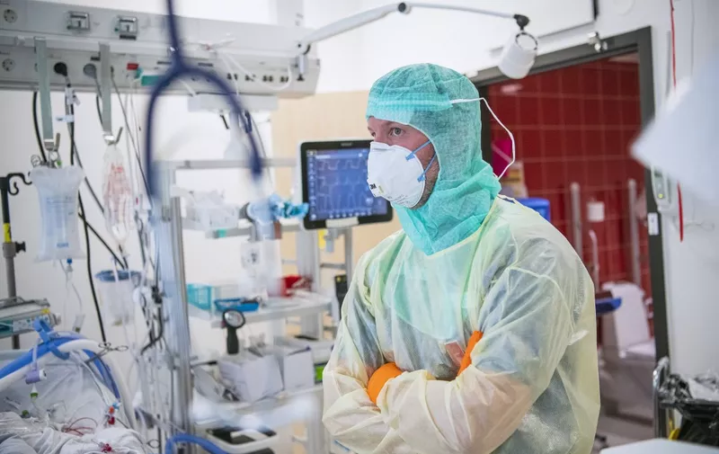 Dr Lars Falk is pictured with protective clothing in a ward with COVID-19 patients at the Extracorporeal Membrane Oxygenation (ECMO) department in the Karolinska hospital in Solna, near Stockholm, Sweden, on April 19, 2020 during the coronavirus COVID-19 pandemic. (Photo by Jonathan NACKSTRAND / AFP)