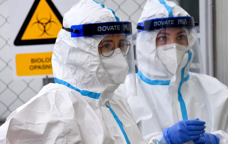 Medical staff members wearing protective equipment, prepare to test people at a Covid-19 drive-in screening test facility in Zagreb, Croatia, on November 12, 2020, as the largest number of people infected with the coronavirus pandemic has been recorded in Croatia. In Europe, which has suffered more than 317,525 deaths from nearly 13,330,000 infections, many countries are struggling with a surging second wave.,Image: 568603351, License: Rights-managed, Restrictions: , Model Release: no