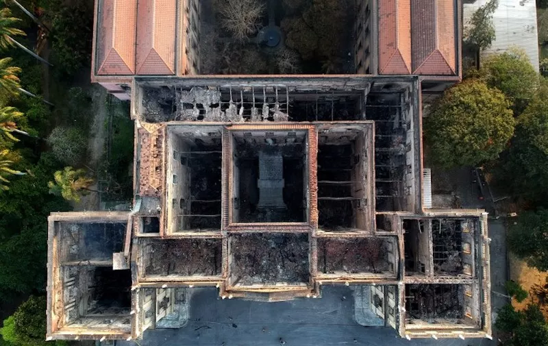 Drone view of Rio de Janeiro's treasured National Museum, one of Brazil's oldest, on September 3, 2018, a day after a massive fire ripped through the building. 
The majestic edifice stood engulfed in flames as plumes of smoke shot into the night sky, while firefighters battled to control the blaze that erupted around 2230 GMT. Five hours later they had managed to smother much of the inferno that had torn through hundreds of rooms, but were still working to extinguish it completely, according to an AFP photographer at the scene. / AFP PHOTO / Mauro Pimentel