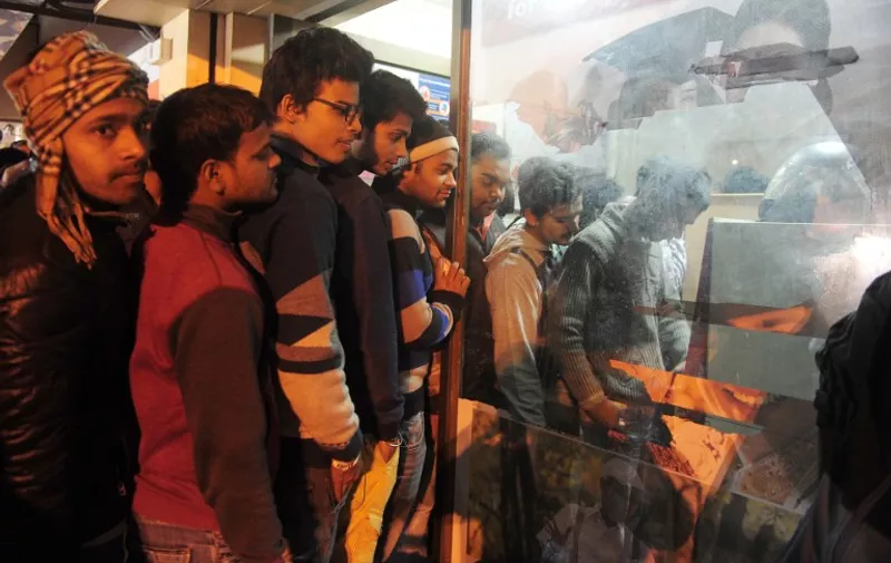 Indian residents queue in a line to withdraw money from an ATM in Allahabad on December 9, 2016.
Prime Minister Narendra Modi unleashed chaos with his shock announcement last month that all 500 and 1,000 rupees ($7.30, $14.60) notes -- some 85 percent of all bills in circulation -- would cease to be legal tender. The move triggered a chronic shortage of cash with people forming long queues outside ATMs and banks. / AFP PHOTO / SANJAY KANOJIA