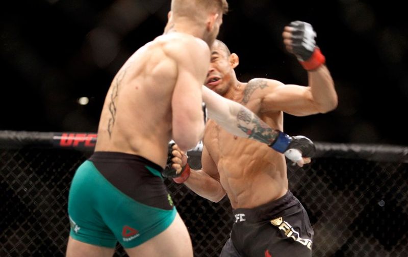 LAS VEGAS, NV - DECEMBER 12: Conor McGregor (L) knocks out Jose Aldo in the first round of their featherweight title fight during UFC 194 on December 12, 2015 in Las Vegas, Nevada.   Steve Marcus/Getty Images/AFP