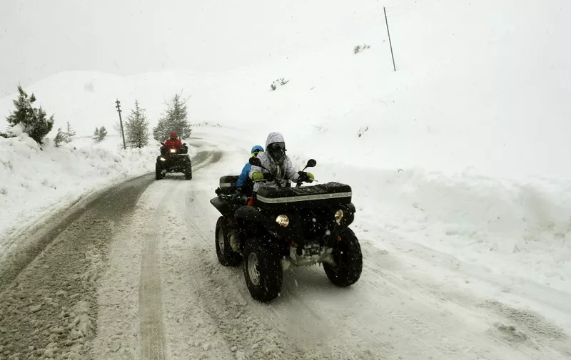 Youths drive their quad bikes on a snow-covered road near the town of Bcharre in mount Lebanon, north of the capital Beirut, on February 19, 2021. (Photo by JOSEPH EID / AFP)