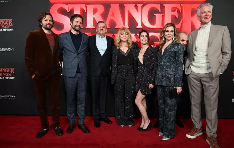 US film writers Matt Duffer and Ross Duffer, The Duffer Brothers (L), Netflix Co-CEO Ted Sarandos (3L), British theatre producer Sonia Friedman (C), US actor David Harbour (2R) and US actor Matthew Modine (R) pose on the red carpet upon arrival to attend the West End world premiere of "Stranger Things: The Last Shadow" stage play at the Phoenix Threatre in central London on December 14, 2023. (Photo by JUSTIN TALLIS / AFP)