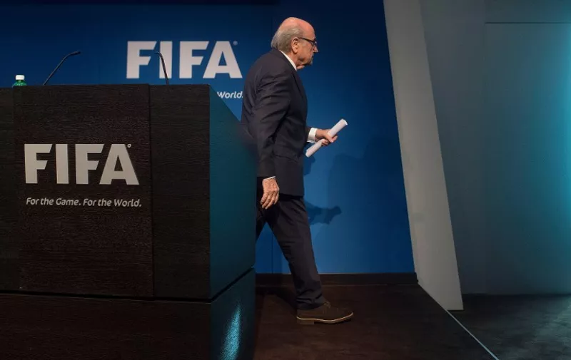 FIFA President Sepp Blatter walks after a press conference at the headquarters of the world's football governing body in Zurich on June 2, 2015. Blatter resigned as president of FIFA as a mounting corruption scandal engulfed world football's governing body. The 79-year-old Swiss official, FIFA president for 17 years and only reelected days ago, said a special congress would be called to elect a successor. AFP PHOTO / 