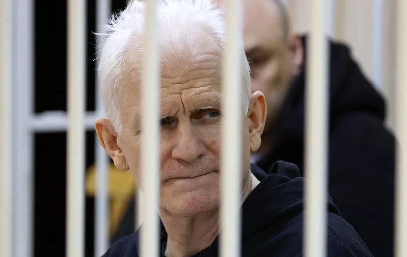 (FILES) In this file photo taken on January 05, 2023 Nobel Prize winner Ales Bialiatski is seen in the defendants' cage in the courtroom at the start of the hearing in Minsk. - A court in Belarus on March 3, 2023 sentenced Nobel Prize winner Ales Bialiatski to 10 years in prison, in a case his supporters see as punishment for his human rights work. The Viasna rights group founded by Bialiatski said in a statement that the 60-year-old had been convicted of smuggling and financing "activities that grossly violate public order". (Photo by Vitaly PIVOVARCHIK / BELTA / AFP) / Belarus OUT