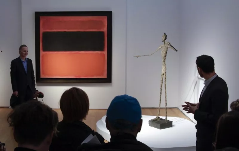 People look at Alberto Giacometti's " L'homme au doigt ", during a media preview on May 1, 2015, at Christie's in New York. Christie's unveiled a special sale of top impressionist, Modern, Post-War and Contemporary works scheduled for May 11, 2015. The Giacometti is estimated at 130 million USD.    AFP PHOTO/EDUARDO MUNOZ ALVAREZ          "MANDATORY MENTION OF THE ARTIST UPON PUBLICATION"