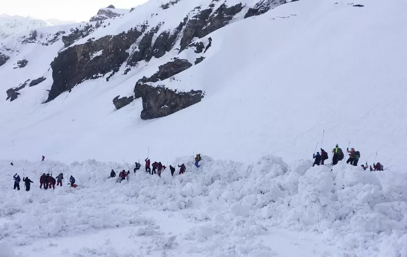 This handout photograph released by the Swiss Police of Canton of Valais - Police Cantonale Valaisanne -  shows rescuers on the site of a avalanche that left four skiers injured above the ski resort of Crans-Montana in the Swiss Alps on February 19, 2019. - An avalanche left four skiers injured at a resort in the Swiss Alps where rescue operations went on after dark with police fearing people could still be trapped under the snow. (Photo by Handout / POLICE CANTONALE VALAISANNE / AFP) / RESTRICTED TO EDITORIAL USE - MANDATORY CREDIT "AFP PHOTO /POLICE CANTONALE VALAISANNE " - NO MARKETING NO ADVERTISING CAMPAIGNS - DISTRIBUTED AS A SERVICE TO CLIENTS ---