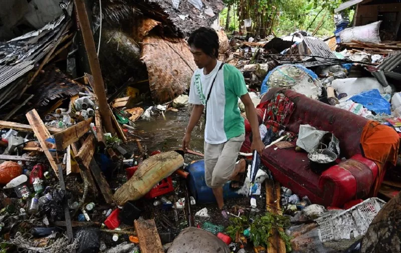 An Indonesian man searches for the body of a relative at a damaged house in Sukarame village in Carita, Banten province on December 24, 2018, two days after a tsunami - caused by activity at a volcano known as the "child" of Krakatoa - hit the west coast of Indonesia's Java island. - The death toll from the volcano-triggered tsunami in Indonesia has risen to 281, with more than 1,000 people injured, the national disaster agency said on December 24, as the desperate search for survivors ramped up. (Photo by ADEK BERRY / AFP)