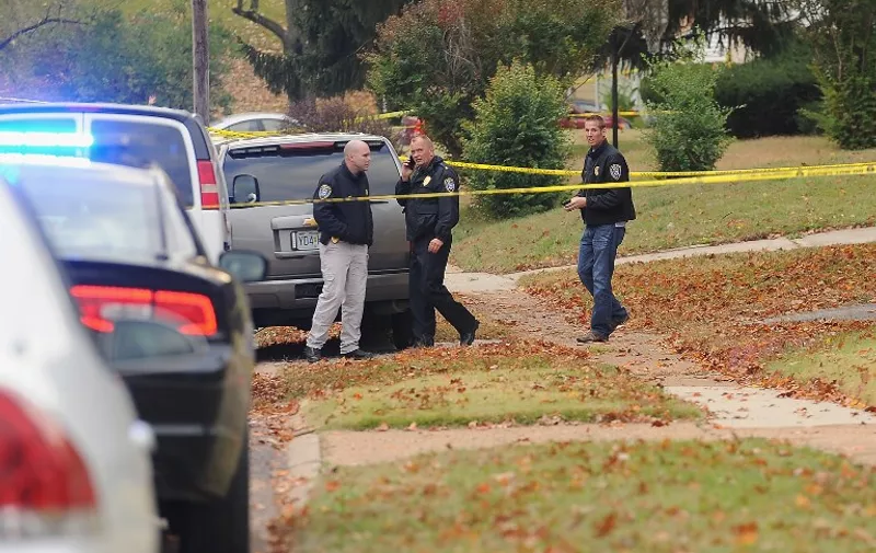 NORMANDY, MO - OCTOBER 28: Police officers stand within a crime scene perimeter while investigating a police-involved shooting in the 7700 Block of Paddington Road on October 28, 2015 in Normandy, Missouri. According to police, a suicidal 18-year-old man shot himself after fleeing an initial police encounter where he fired on responding officers.   Michael B. Thomas/Getty Images/AFP