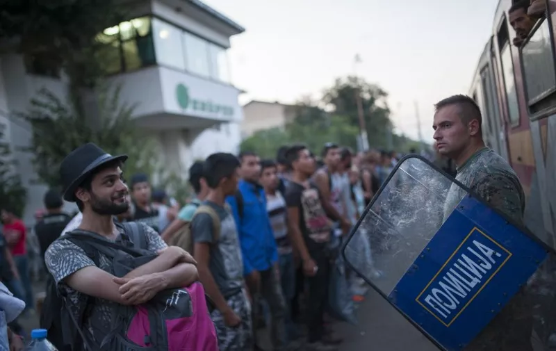 Migrants wait for a train to Serbia in the town of Gevgelija, on the Macedonian-Greek border, on August 19, 2015. The migrants, among them children and elderly people are trying to cross Macedonia and Serbia to enter the EU via Hungary. Hungarian authorities started building a fence along the country's border with Serbia earlier this week to halt the migrant influx. AFP PHOTO / ROBERT ATANASOVSKI