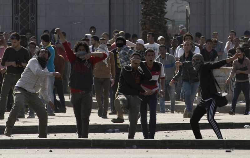 Egyptian students who support the Muslim Brotherhood and ousted Islamist president Mohamed Morsi clash with riot police following a demonstration outside Cairo University on March 26, 2014. The demonstration was organised to protest against a court ruling that sentenced to death 529 Islamists for the murder and attempted murder of several policemen during riots in the southern city of Minya on August 14. AFP PHOTO / KHALED DESOUKI / AFP PHOTO / KHALED DESOUKI