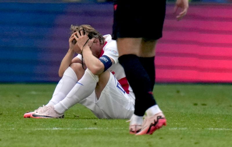 Croatia's Luka Modric, bottom reacts at the end of a Group B match between Croatia and Albania at the Euro 2024 soccer tournament in Hamburg, Germany, Wednesday, June 19, 2024. (AP Photo/Petr Josek)