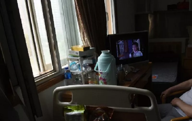 TO GO WITH China-social-healthcare-demographics,FEATURE by Carol HUANG
This photo taken on June 30, 2014 shows an elderly man watching TV in his room at the Yiyangnian nursing home, a privately run aged care facility, in Beijing. China's elderly population is expanding so quickly that children struggle to look after them while caregivers are either unaffordable or unavailable -- prompting a scramble for solutions, even ones bucking age-old traditions that families should care for their own across the generations.    AFP PHOTO / Greg BAKER / AFP / GREG BAKER