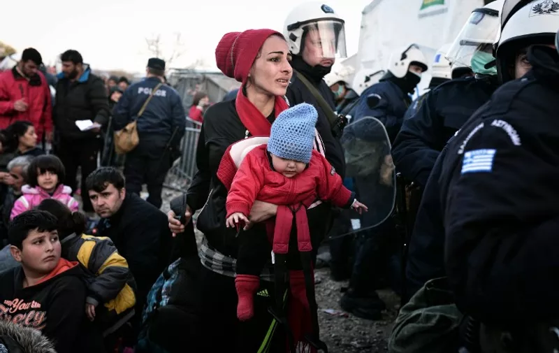 A woman looks for her husband and son as she is allowed to cross into Macedonia at the Greek-Macedonian border, near the Greek village of Idomeni, on March 2, 2016, where thousands of people are stranded.
The EU on March 2 proposed 700 million euros in emergency aid for Greece and other states as it began to tackle the migrant crisis within its borders like humanitarian disasters in developing countries. The United Nations has warned of a looming humanitarian crisis as thousands of people remained stuck in miserable winter conditions on the Greece-Macedonia border after Balkans states and Austria capped the numbers arriving. 
 / AFP / LOUISA GOULIAMAKI