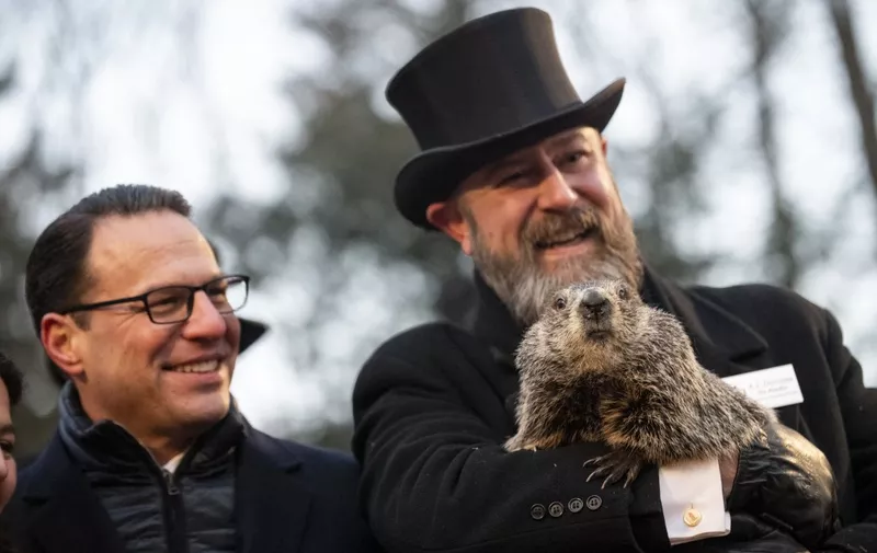 PUNXSUTAWNEY, PA - FEBRUARY 02: Pennsylvania Governor Josh Shapiro poses for a portrait with Groundhog handler AJ Dereume and Punxsutawney Phil, who saw his shadow, predicting a late spring during the 137th annual Groundhog Day festivities on February 2, 2023 in Punxsutawney, Pennsylvania. Groundhog Day is a popular tradition in the United States and Canada. A crowd of upwards of 5000 people spent a night of revelry awaiting the sunrise and the groundhog's exit from his winter den. If Punxsutawney Phil sees his shadow he regards it as an omen of six more weeks of bad weather and returns to his den. Early spring arrives if he does not see his shadow, causing Phil to remain above ground.   Michael Swensen/Getty Images/AFP (Photo by Michael Swensen / GETTY IMAGES NORTH AMERICA / Getty Images via AFP)