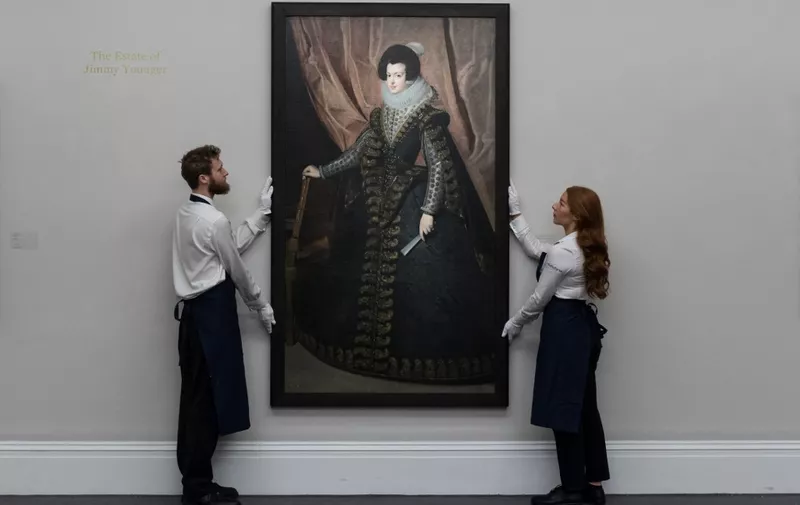 LONDON, UNITED KINGDOM - DECEMBER 01, 2023: Technicians look at a painting by Diego Rodriguez de Silva y Velazquez, Portrait of Isabel de Borbon, Queen of Spain, Full-Length, valued in region of $35m which will be offered at an auction at Sothebys New York in February 2024 during a photocall at Sotheby's auction house in London, United Kingdom on December 01, 2023. (Photo by WIktor Szymanowicz/NurPhoto) (Photo by WIktor Szymanowicz / NurPhoto / NurPhoto via AFP)