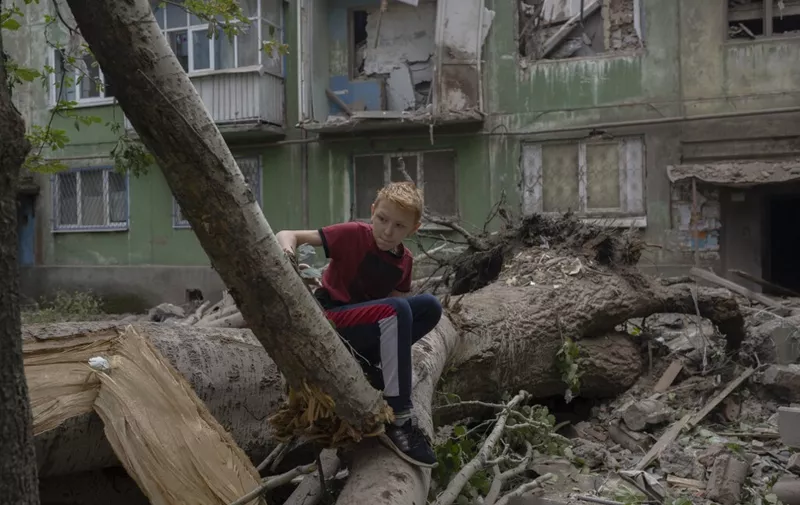 A teenager looks at the damages after an early morning Russian forces' strike in Kostiantynivka, eastern Ukraine, amid the Russian invasion of Ukraine. - In Pokrovsk, 85 kilometres (53 miles) to the south of Kramatorsk, the main city in the Ukrainian-held part of the region, a strike destroyed or damaged a dozen homes on a single street last week. There have been similar and often deadly strikes in Kostiantynivka, Toretsk and even in Kramatorsk, further from the front line. (Photo by Bulent KILIC / AFP)