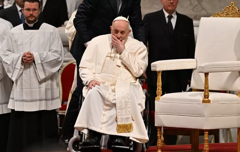 Pope Francis, seated in a wheelchair, leaves after leading the Easter Vigil mass on April 8, 2023 at St. Peter's basilica in The Vatican, as part of celebrations of the Holy Week. (Photo by Andreas SOLARO / AFP)