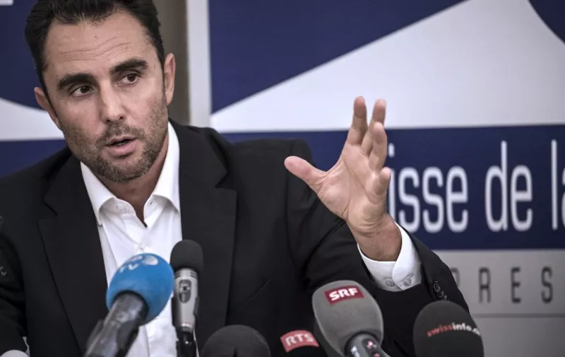 (FILES) -- A file photo taken on October 28, 2015 shows Herve Falciani, the former HSBC employee who leaked documents alleging the bank helped clients evade millions of dollars in taxes, gesturing during a press conference in Divonne-les Bains. Falciani failed again to show up for his Swiss trial on November 2, 2015, which opened in his absence. Herve Falciani, a 43-year-old French-Italian national who exposed the so-called Swissleaks scandal, has repeatedly said he would not travel to Switzerland for the trial and already failed to show for his initial court date last month, so his absence did not come as a surprise.   AFP PHOTO / JEAN-PHILIPPE KSIAZEK / AFP / JEAN-PHILIPPE KSIAZEK