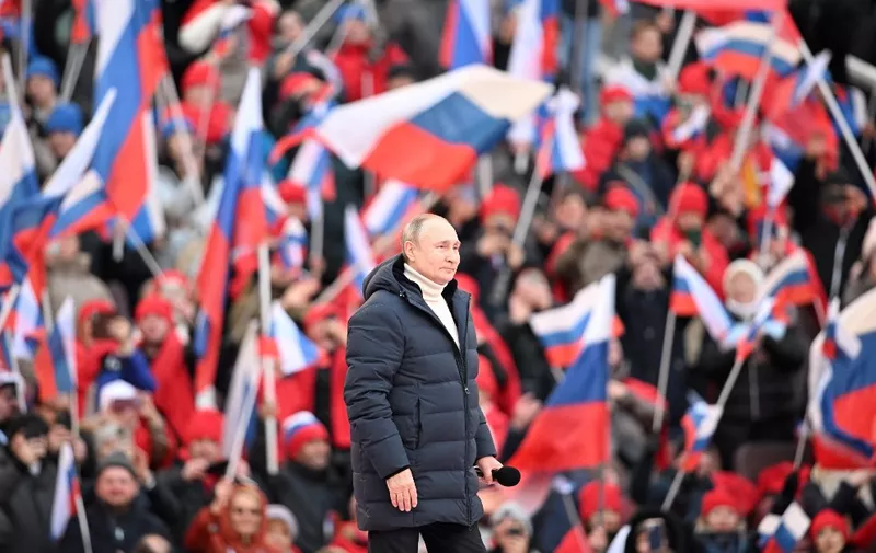 Russian President Vladimir Putin attends a concert marking the eighth anniversary of Russia's annexation of Crimea at the Luzhniki stadium in Moscow on March 18, 2022. (Photo by Ramil SITDIKOV / POOL / AFP)