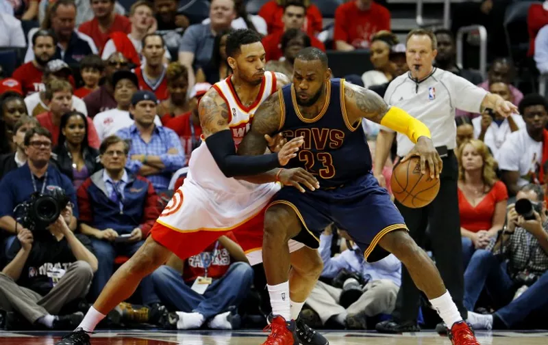ATLANTA, GA - MAY 22: LeBron James #23 of the Cleveland Cavaliers drives against Mike Scott #32 of the Atlanta Hawks in the fourth quarter during Game Two of the Eastern Conference Finals of the 2015 NBA Playoffs at Philips Arena on May 22, 2015 in Atlanta, Georgia. NOTE TO USER: User expressly acknowledges and agrees that, by downloading and or using this Photograph, user is consenting to the terms and conditions of the Getty Images License Agreement.   Kevin C. Cox/Getty Images/AFP