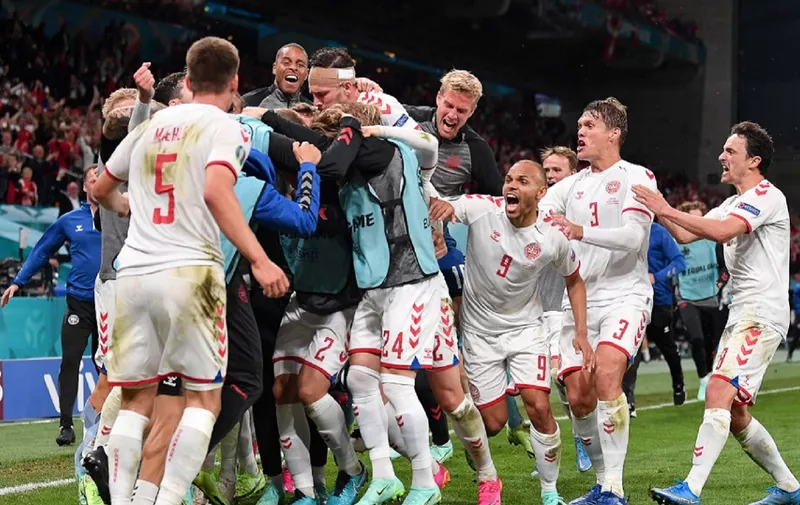Denmark's players celebrate after scoring their third goal during the UEFA EURO 2020 Group B football match between Russia and Denmark at Parken Stadium in Copenhagen on June 21, 2021. (Photo by Stuart Franklin / POOL / AFP)