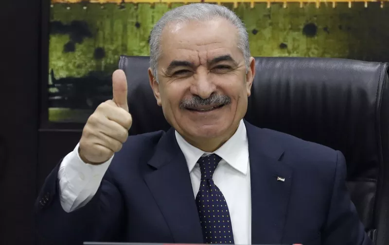 Palestinian Prime Minister Mohammad Shtayyeh gives a thumb up at a cabinet meeting during which he announced his government's resignation and called for "new political measures" in Ramallah on February 26, 2024, amid the ongoing war in the Gaza Strip. "The next stage and its challenges require new governmental and political measures that take into account the new reality in the Gaza Strip," he said, as he called for inter-Palestinian consensus and the "extension of the (Palestinian) Authority's rule over the entire land of Palestine". (Photo by Zain JAAFAR / AFP)