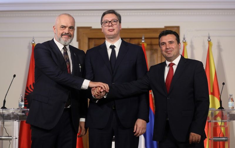 Albanian Prime Minister Edi Rama (L), Serbian President Aleksandar Vucic (C) and North Macedonian Prime Minister Zoran Zaev shake hands after their joint press conference after their meeting to discuss easing of customs barriers between their countries in Novi Sad, Serbia, on October 10, 2019. (Photo by OLIVER BUNIC / AFP)