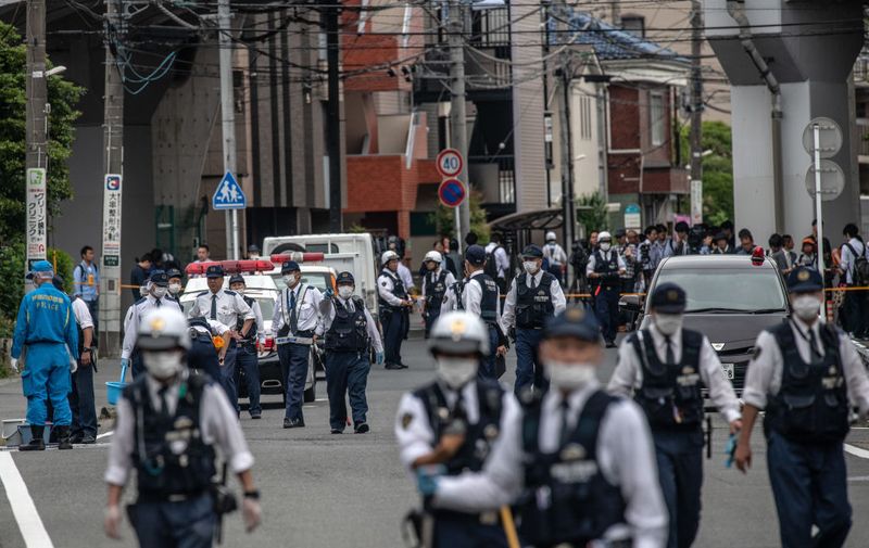 KAWASAKI, JAPAN - MAY 28: Police officers work at the scene of a mass stabbing on May 28, 2019 in Kawasaki, Japan. A schoolgirl and a 39-year-old man were killed by a knife-wielding man while at least 16 people were reportedly injured when the assailant attacked a group of elementary-school girls at a bus stop. The suspect, believed to be in his 50s, reportedly stabbed himself in the neck and subsequently died from his injuries. A motive for the attack has not yet been established. (Photo by Carl Court/Getty Images)