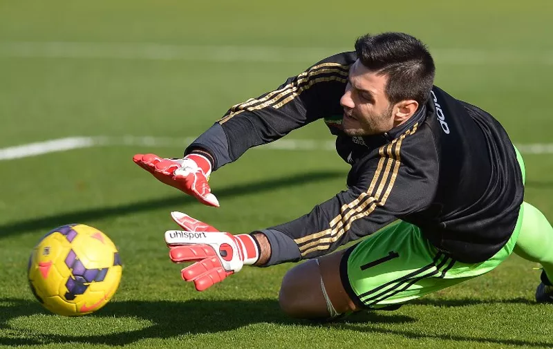 AC Milan's goalkeeper Marco Amelia warms up prior the Italian Serie A football match between Cagliari and AC Milan on January 26, 2014 at the Sant'Elia stadium in Cagliari.  AFP PHOTO / GABRIEL BOUYS