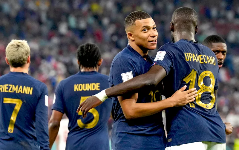 France's Kylian Mbappe is greeted by Dayot Upamecano after scoring his side's opening goal against Denmark during a World Cup group D soccer match at the Stadium 974 in Doha, Qatar, Saturday, Nov. 26, 2022. (AP Photo/Martin Meissner)