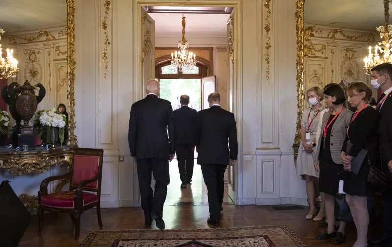 Swiss Federal president Guy Parmelin (C) US president Joe Biden (L) and Russian president Vladimir Putin walk out to meet the media after their arrival at the villa La Grange, during the US - Russia summit in Geneva, on June 16, 2021. (Photo by PETER KLAUNZER / POOL / AFP)