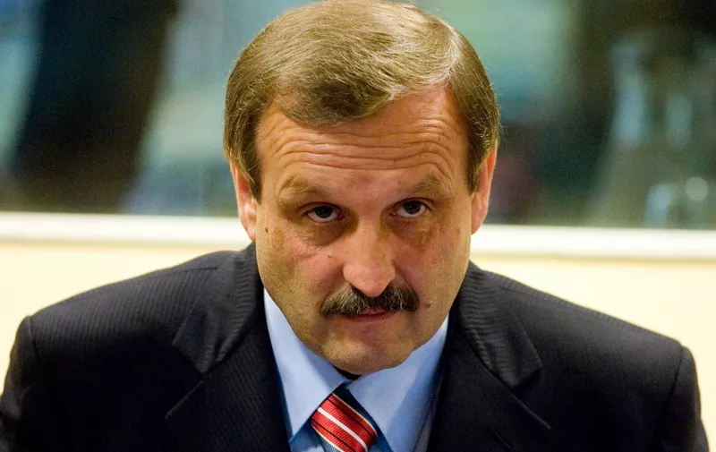 Former rebel Croatian Serb leader Milan Martic attends 12 June 2007 a session of the UN war crimes tribunal, which convicted him over atrocities committed against Croat civilians and sentenced him to 35 years in prison. Martic, 52, a one-time close ally of former Yugoslav President Slobodan Milosevic, held various leadership positions in the rebel Serbs' self-proclaimed autonomous Krajina region in Croatia between January 1991 and August 1995. He was found guilty on nine charges of crimes against humanity and seven counts of war crimes including persecution, murder, torture, deportation and attacks on civilians.  AFP PHOTO / POOL / FRED ERNST (Photo by FRED ERNST / POOL / AFP)