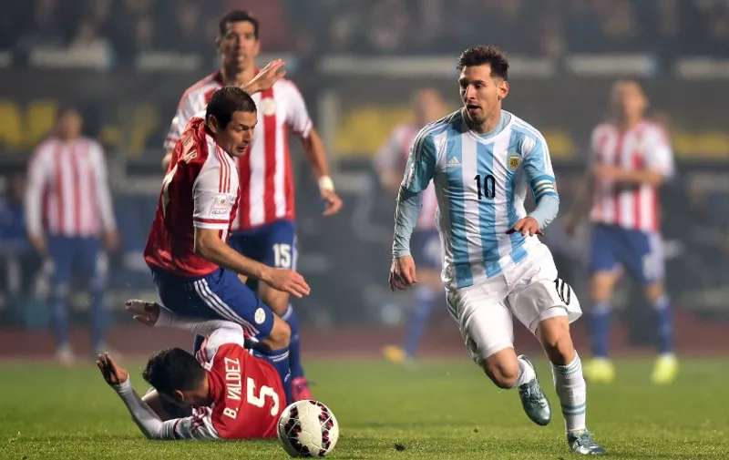 Argentina's forward Lionel Messi (R) is marked by Paraguay's defenders Bruno Valdez, Pablo Cesar Aguilar and midfielder Victor Caceres during their Copa America semifinal football match in Concepcion, Chile on June 30, 2015.   AFP PHOTO / YURI CORTEZ