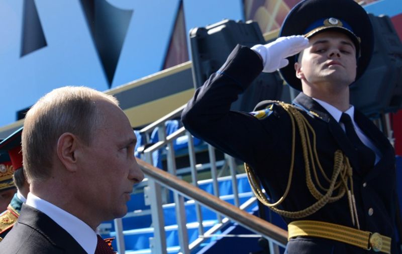 Russia's President Vladimir Putin attends a Victory Day parade at the Red Square in Moscow, on May 9, 2014. Thousands of Russian troops marched today in Red Square to mark 69 years since victory in World War II in a show of military might amid tensions in Ukraine following Moscow's annexation of Crimea. AFP PHOTO / KIRILL KUDRYAVTSEV