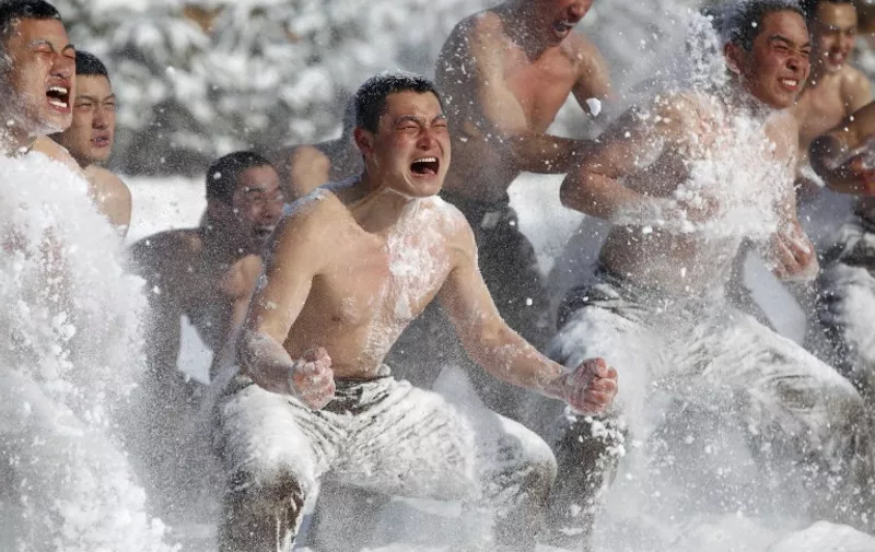 This picture taken on February 26, 2015 shows Chinese People's Liberation Army (PLA) soldiers training in the snow in Heihe, northeast China's Heilongjiang province. China's military training this year will focus on "improving fighting capacity" to win "local wars", the defence ministry said, with Beijing embroiled in several territorial disputes. CHINA OUT     AFP PHOTO