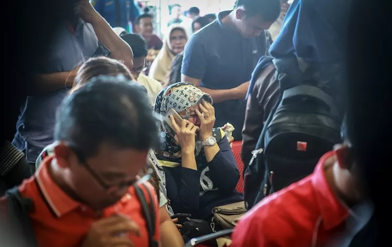 Family members of the crashed Indonesian Lion Air JT-610 react at Pangkal Pinang airport, in Bangka Belitung province on October 29, 2018. - An Indonesian Lion Air plane carrying 188 passengers and crew crashed into the sea on October 29, 2018, officials said, moments after it had asked to be allowed to return to Jakarta. (Photo by HADI SUTRISNO / AFP)