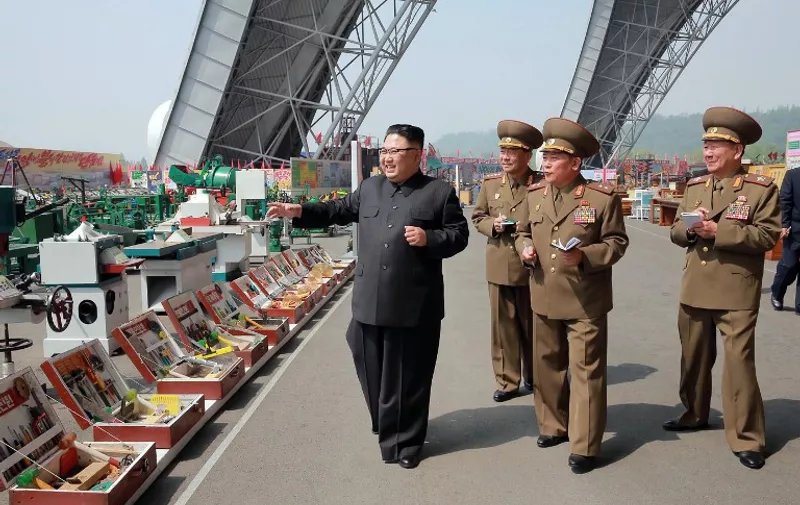 This undated photo released by North Korea's official Korean Central News Agency (KCNA) on May 13, 2017 shows North Korean leader Kim Jong-Un (L) at an exhibition of utensils and tools, finishing building materials and sci-tech achievements organised by the Ministry of the People's Armed Forces.
 / AFP PHOTO / KCNA via KNS / STR / South Korea OUT / REPUBLIC OF KOREA OUT   ---EDITORS NOTE--- RESTRICTED TO EDITORIAL USE - MANDATORY CREDIT "AFP PHOTO/KCNA VIA KNS" - NO MARKETING NO ADVERTISING CAMPAIGNS - DISTRIBUTED AS A SERVICE TO CLIENTS
THIS PICTURE WAS MADE AVAILABLE BY A THIRD PARTY. AFP CAN NOT INDEPENDENTLY VERIFY THE AUTHENTICITY, LOCATION, DATE AND CONTENT OF THIS IMAGE. THIS PHOTO IS DISTRIBUTED EXACTLY AS RECEIVED BY AFP.  /