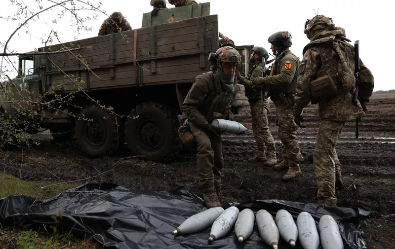 Ukrainian artillerymen of the Aidar battalion work with artillery shells on a front line position near Bakhmut, Donetsk region, on April 22, 2023, amid the Russian invasion on Ukraine. (Photo by Anatolii STEPANOV / AFP)